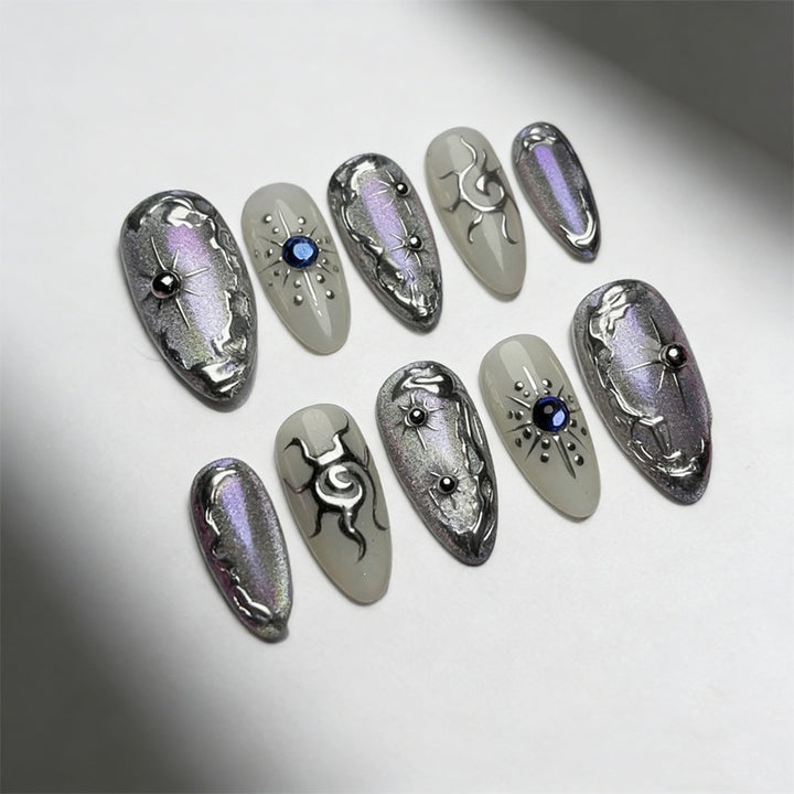 Kunstnagelset mit glänzendem Metallic-Effekt und eleganten Verzierungen Karnz
