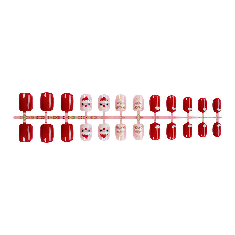 Kunstnagelset mit festlichen Weihnachtsmotiven und Glitzerakzenten Karnz