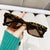 Damen moderne, geometrische Sonnenbrille mit stilvollem, robustem Rahmen Karnz