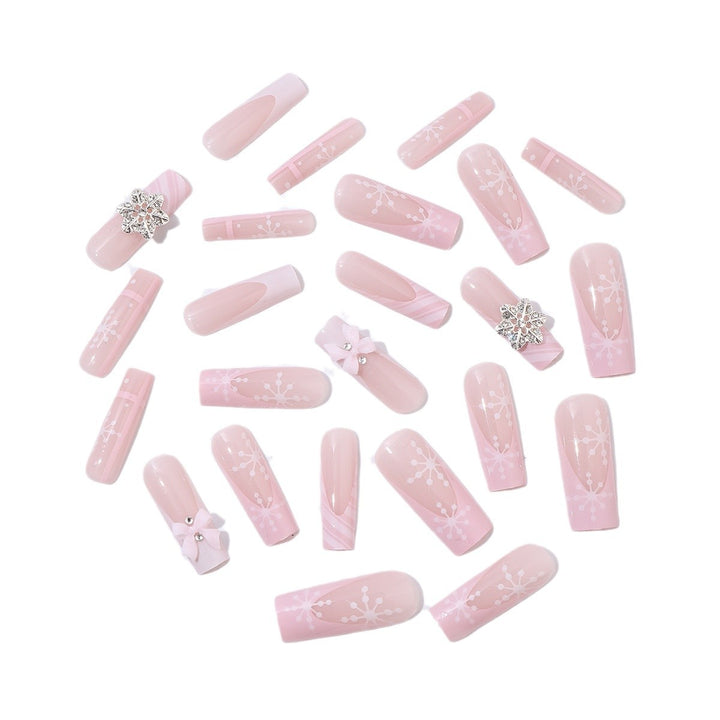 Kreatives Kunstnagelset mit zarten Blumen- und Glitzerakzenten Karnz