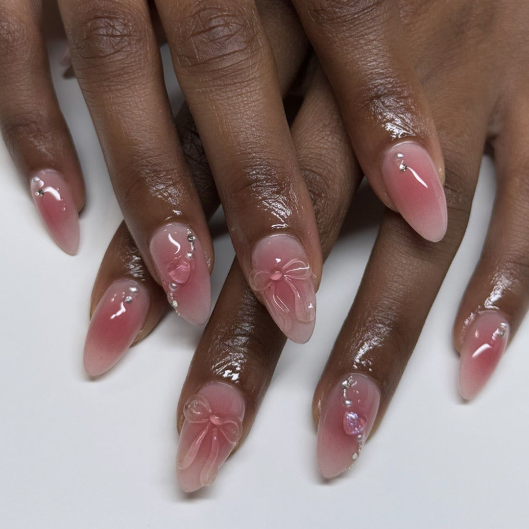 Kunstvolle Nagelverlängerungen mit zarten Blütenakzenten und Glitzer Karnz
