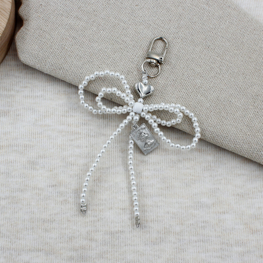 Elegante perlenbesetzte Schleifenbrosche Karnz