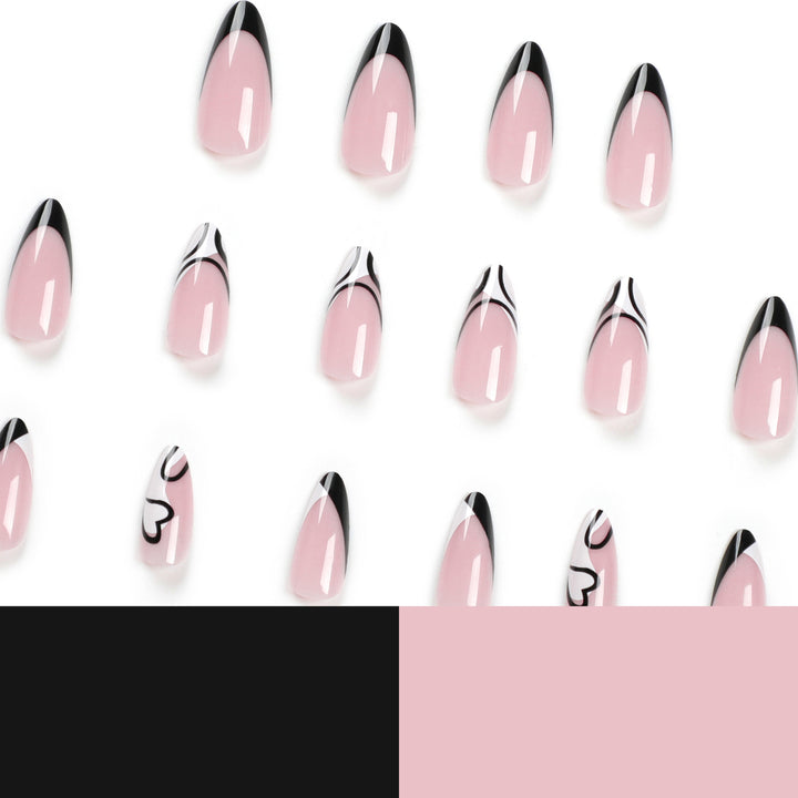 Kunstvolle Stiletto-Nägel mit elegantem Schwarz-Weiß-Design Karnz