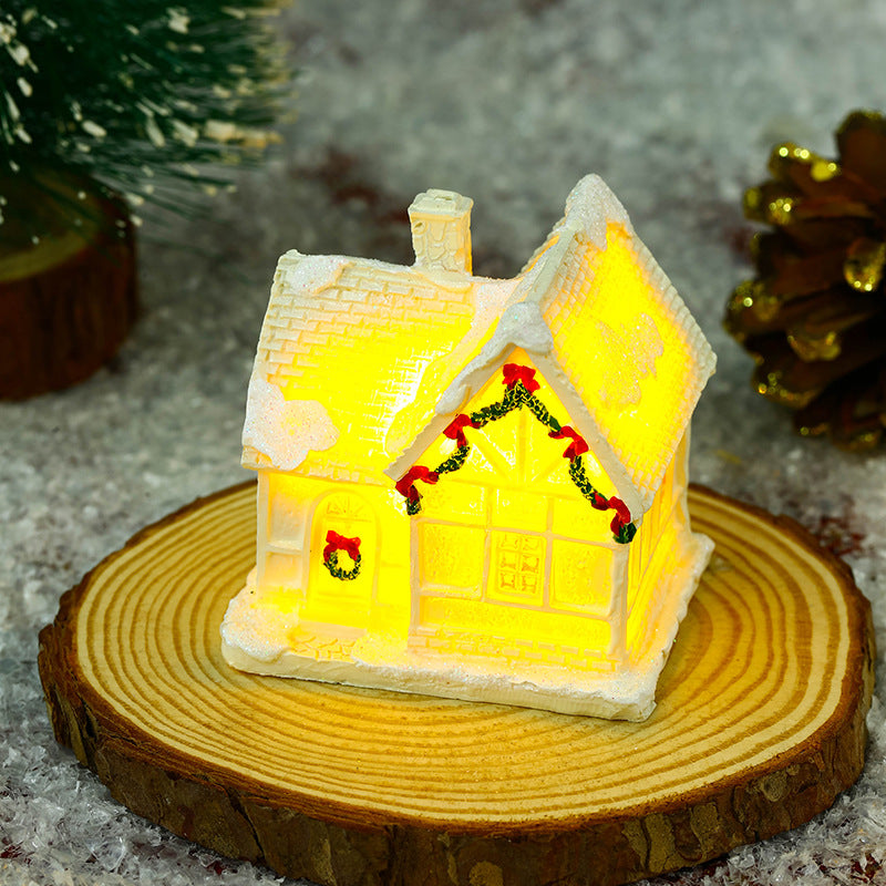 Beleuchtetes Weihnachtsdorfhaus mit festlicher Dekoration Karnz