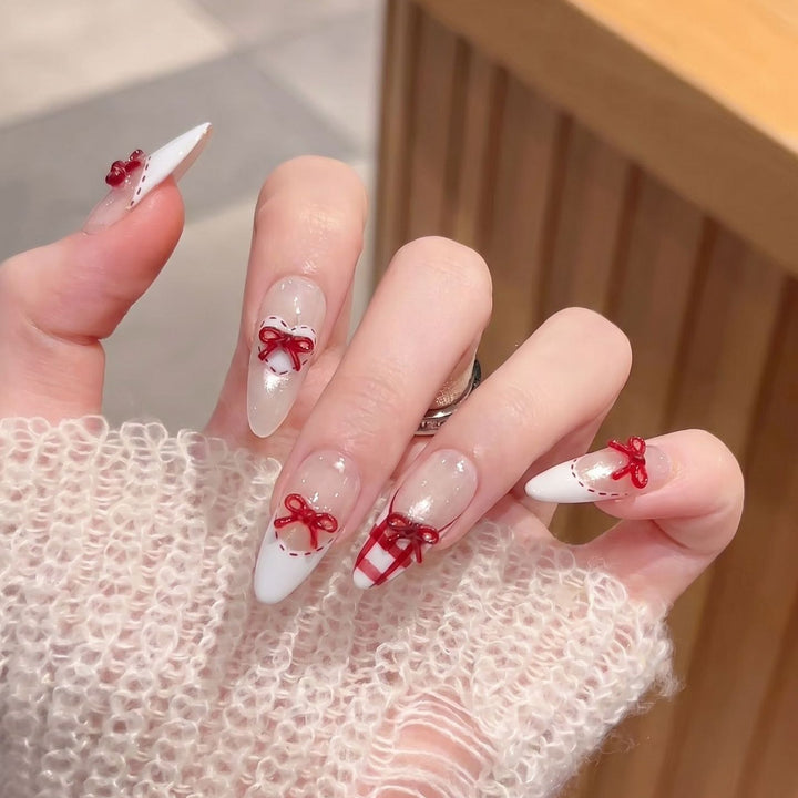 Dekorativer Stiletto Press-On Nagelset mit Schleifenakzenten Karnz