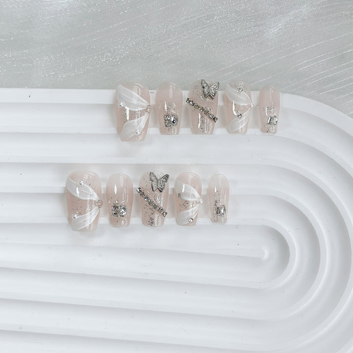 Elegantes dekoratives Press-On-Nagelkunstset mit silbernen Schmetterlingen und Edelsteindetails