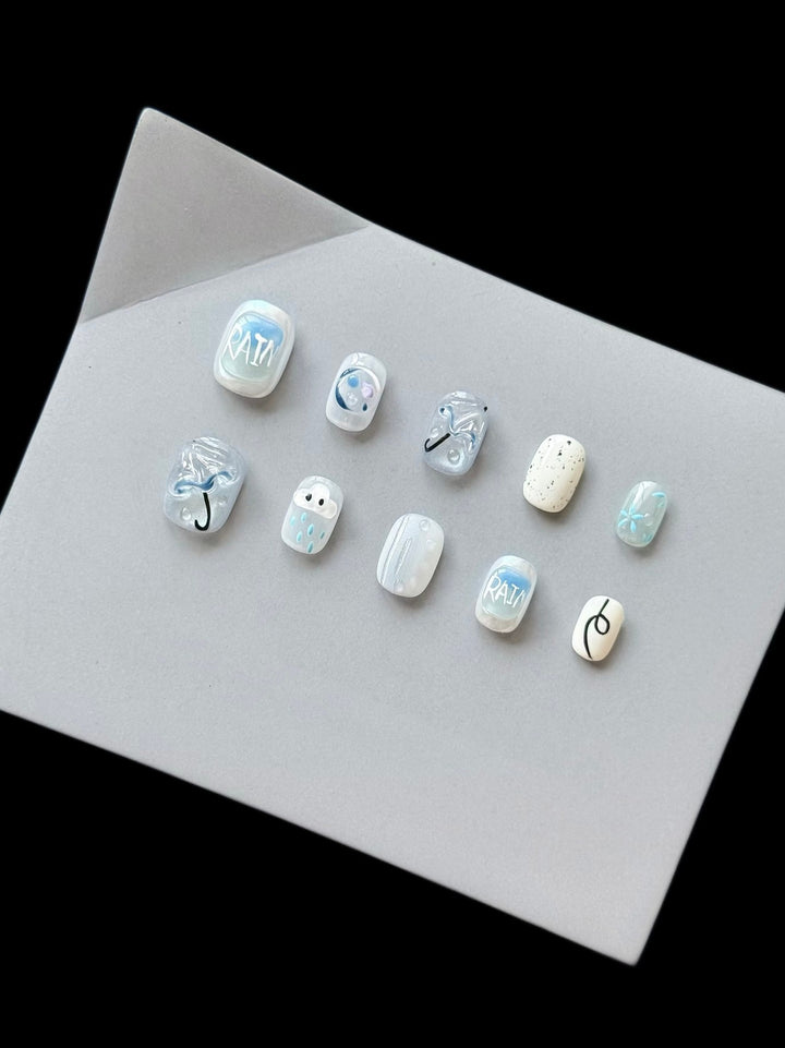 Künstlerisches Press-On Nagelset mit Regen-Thema