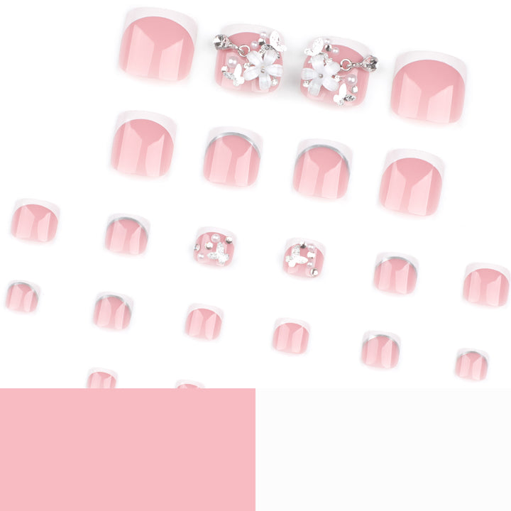 Kunstvolle Fußnagelgestaltung mit eleganten Blüten- und Glitzerakzenten Karnz