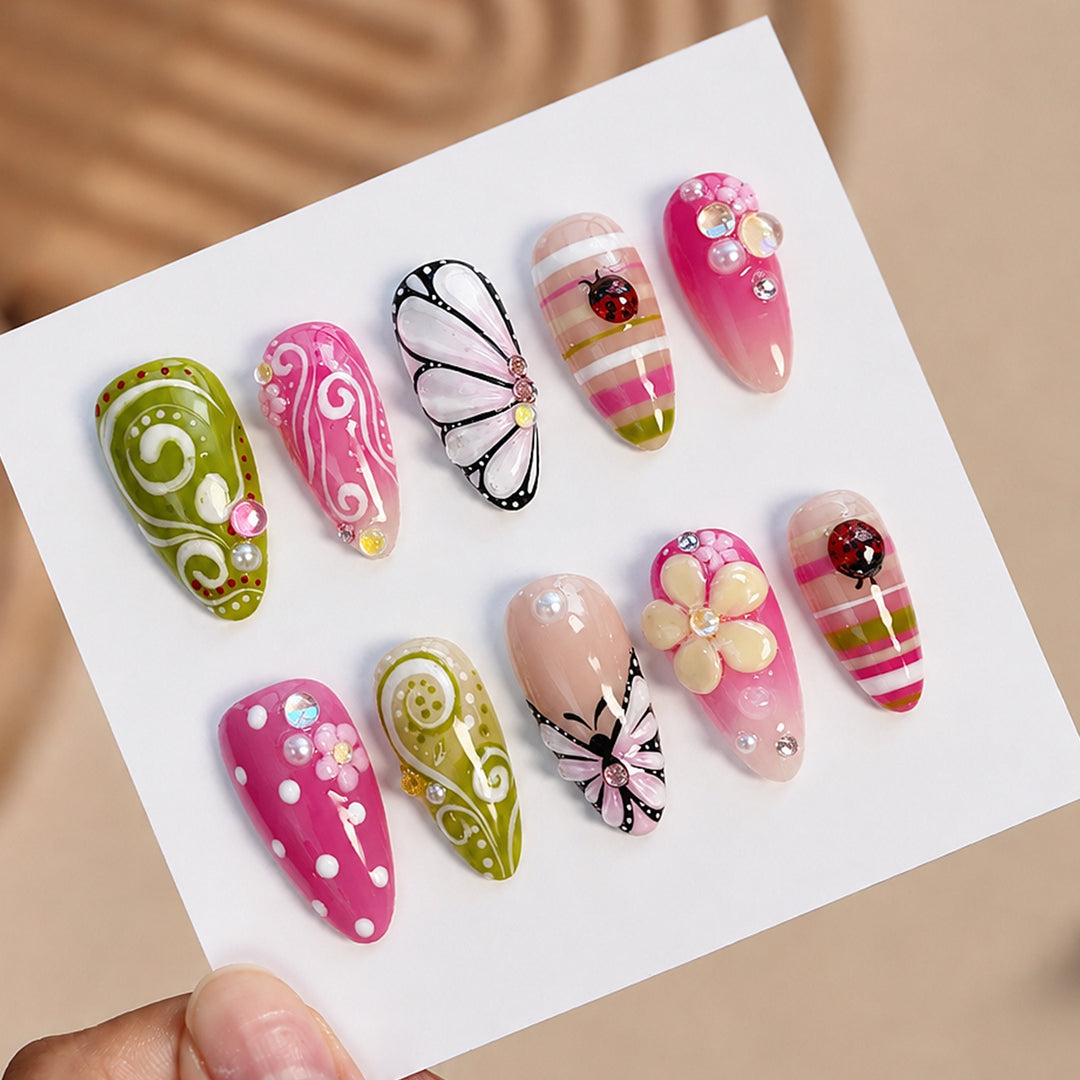 Kunstnagelset mit verspielten Blumen- und Glitzermotiven Karnz