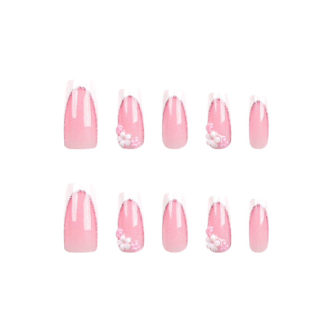 Kunstvolle Nagelverlängerungen mit Glitzer- und Blumenakzenten Karnz