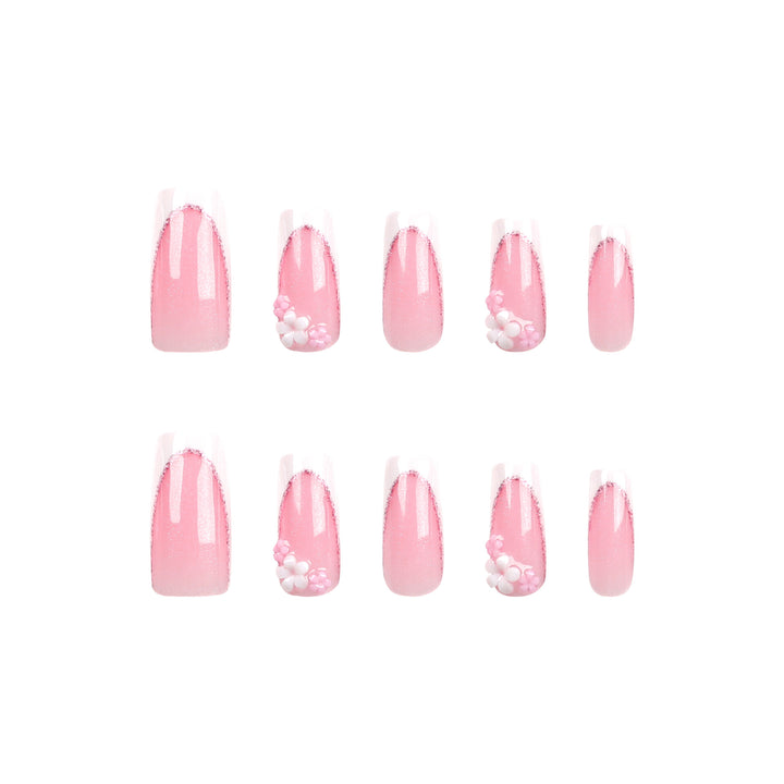 Kunstvolle Nagelverlängerungen mit Glitzer- und Blumenakzenten Karnz