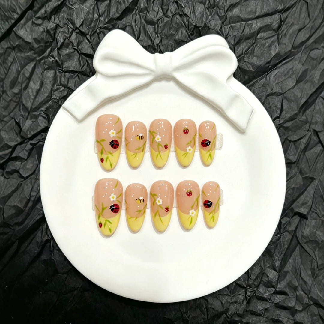 Künstlerisches Press-On-Nagelset mit floralen und Insektendesigns