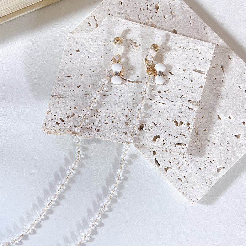Elegante Ohrringe mit Perlen und Blütenanhängern Karnz
