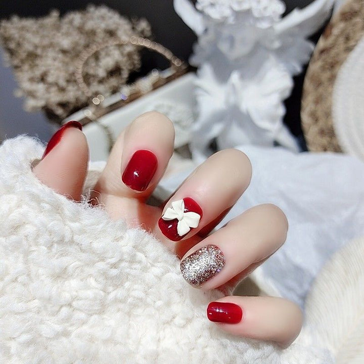 Dekorativer Press-On Nagelkunst-Set mit Schleifenakzent Karnz