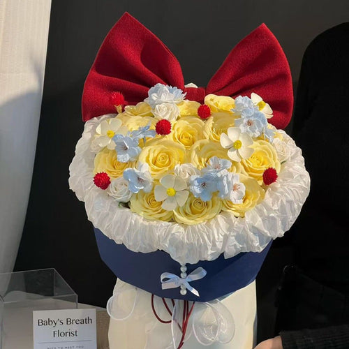 Künstliches Blumenarrangement mit Schleifenakzent