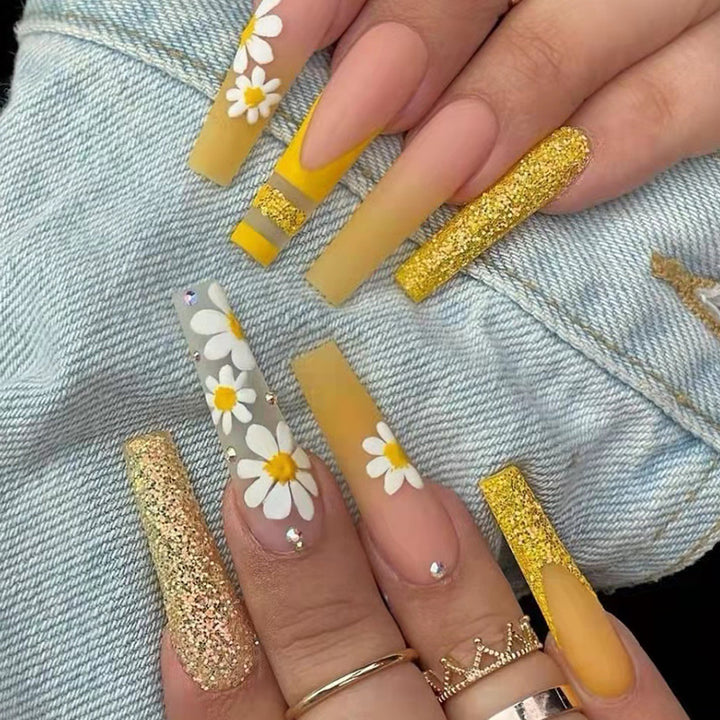 Kunstnagelset mit bunten Sonnenblumenmotiven und glitzernden Akzenten Karnz