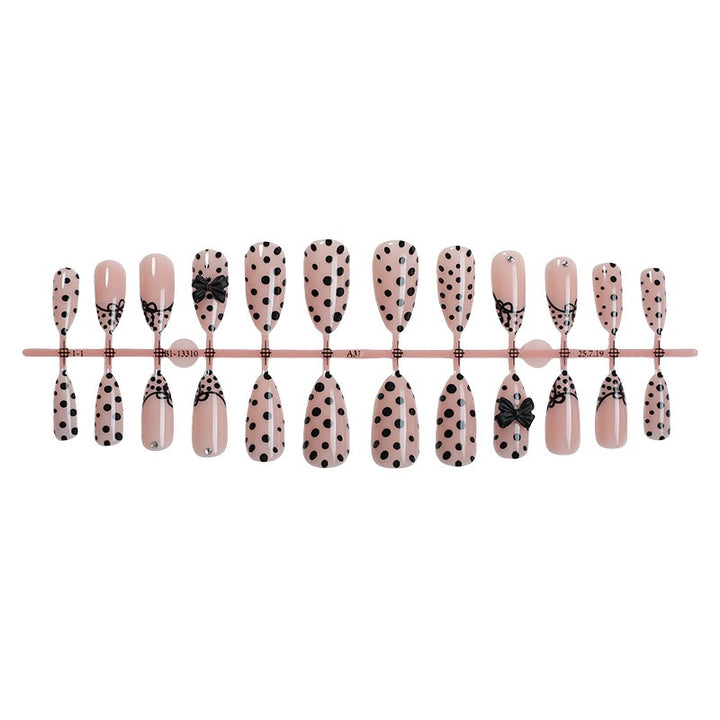 Kunstnagelset mit eleganten Punkte- und Schleifenmotiven Karnz