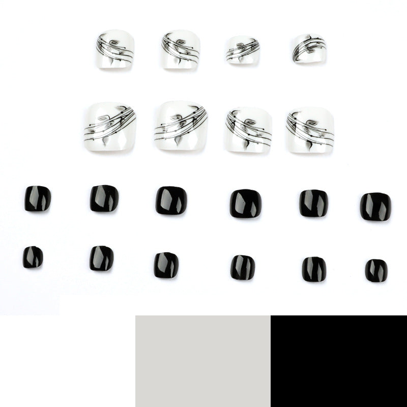 Kunstvolle Fußnagelkunst im eleganten Schwarz-Weiß-Design Karnz