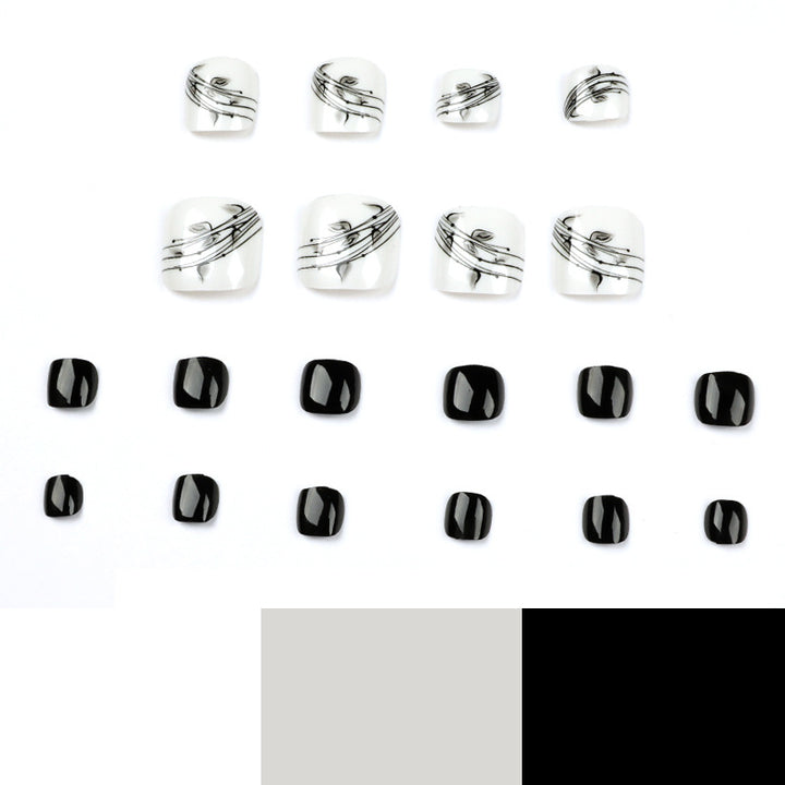 Kunstvolle Fußnagelkunst im eleganten Schwarz-Weiß-Design Karnz