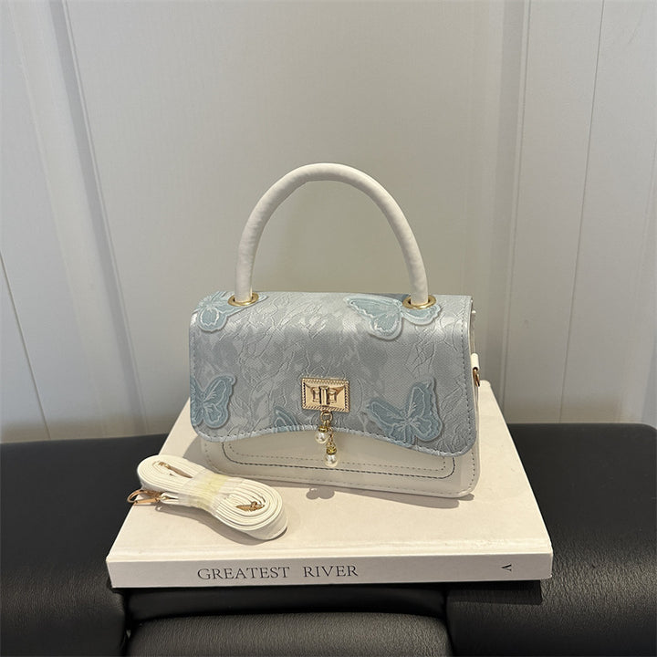 Elegante blumengemusterte Abendhandtasche