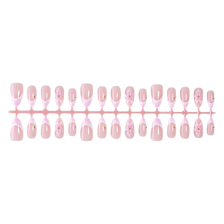 Kreatives Kunstnagelset mit zarten Blüten- und Glitzerdetails Karnz