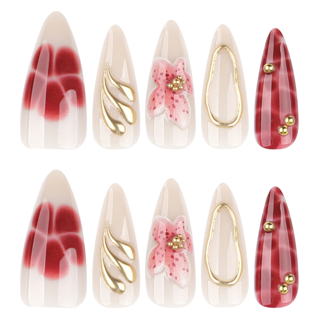 Kunstvolle Stiletto-Nägel mit eleganten Blumendesigns und Glitzerakzenten Karnz