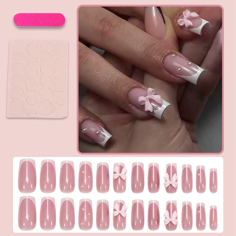 Kunstnagelset mit verspielten Schleifendesigns und eleganten Akzenten Karnz