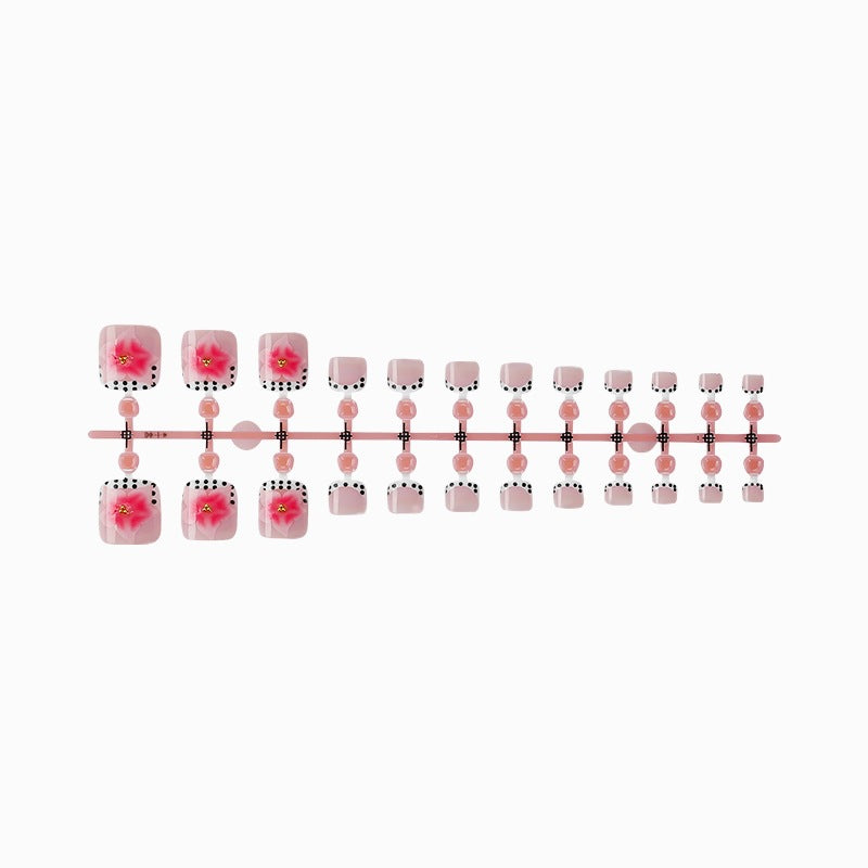 Kunstnagelset mit eleganten Blüten- und Punkte-Design Karnz