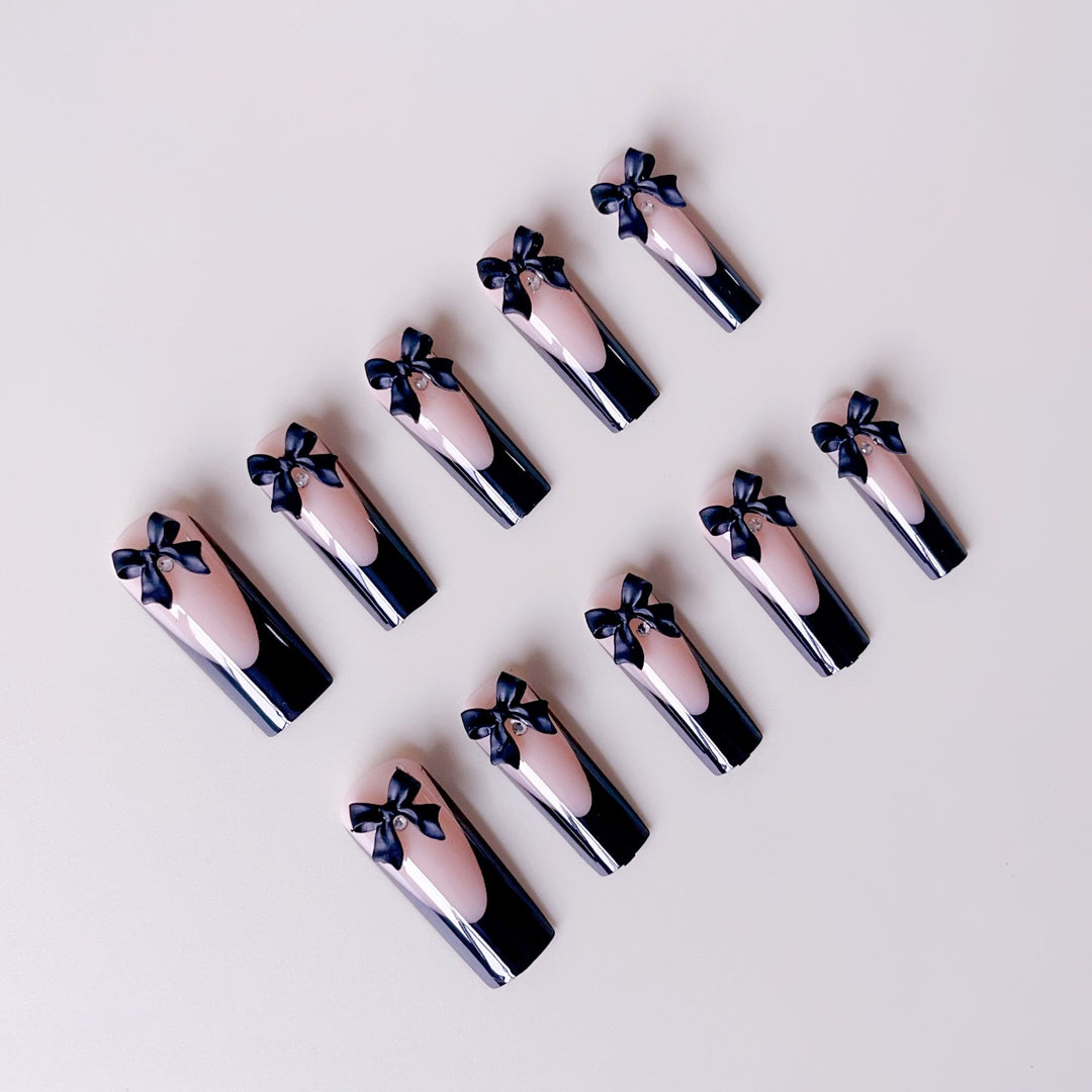 Elegante Kunstnagelspitzen mit Schleifenverzierungen Karnz