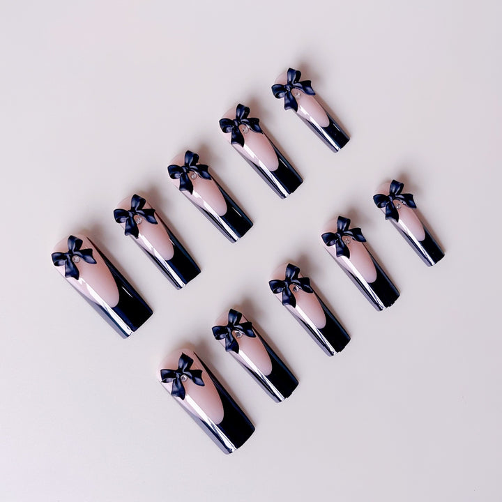 Elegante Kunstnagelspitzen mit Schleifenverzierungen Karnz