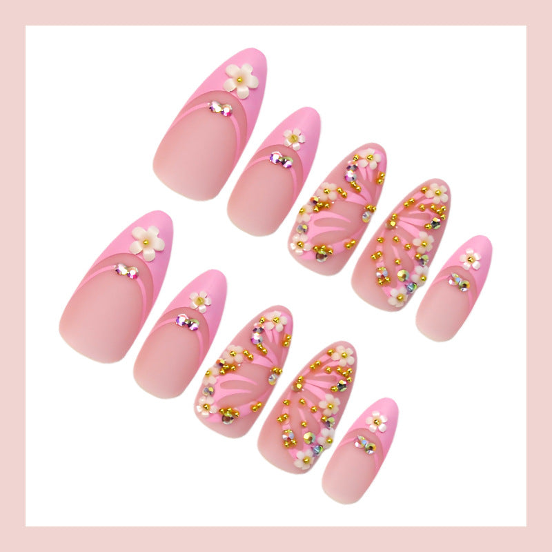 Kunstnagelset mit eleganten Blüten- und Glitzerverzierungen Karnz