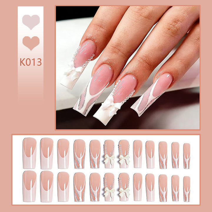 Kunstnagelset mit eleganten Schleifen- und Perlverzierungen Karnz