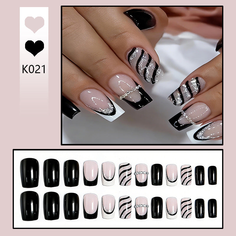 Elegante Kunstnägel mit Glitzer- und Streifenakzenten Karnz