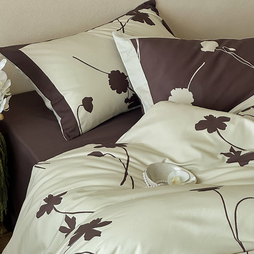 Wendbare Baumwollsatin-Bettwäschegarnitur mit floralem Silhouetten-Print und kontrastierender Kederkante