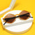 Damen stylische geometrische Sonnenbrille mit elegantem Rahmen Karnz