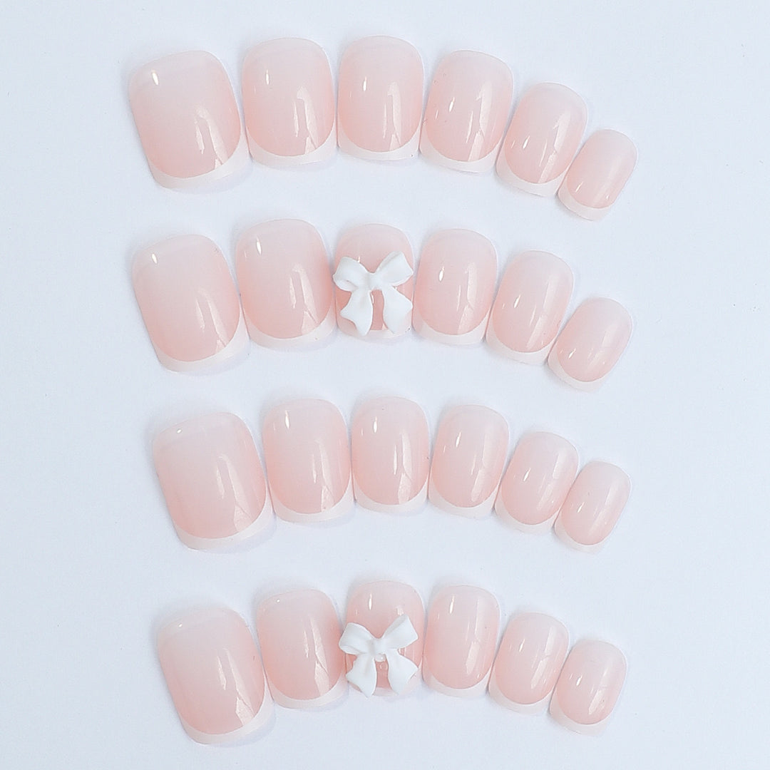 Kunstnagelset mit eleganten französischen Spitzen und romantischen Blütenverzierungen Karnz