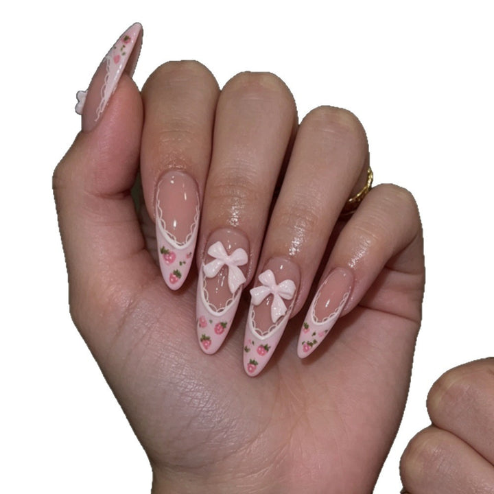 Elegante Stiletto Press-On Nägel mit floralem und Schleifenakzenten Karnz