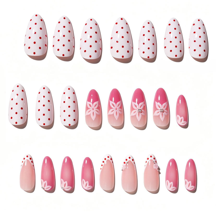Kunstnagelset mit floralen Akzenten und charmanten Polka-Dots Karnz
