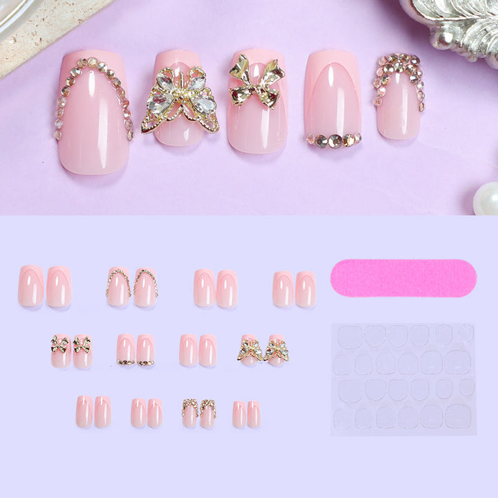 Glamouröses Kunstnagelset mit floralen Akzenten und Glitzerverzierungen Karnz