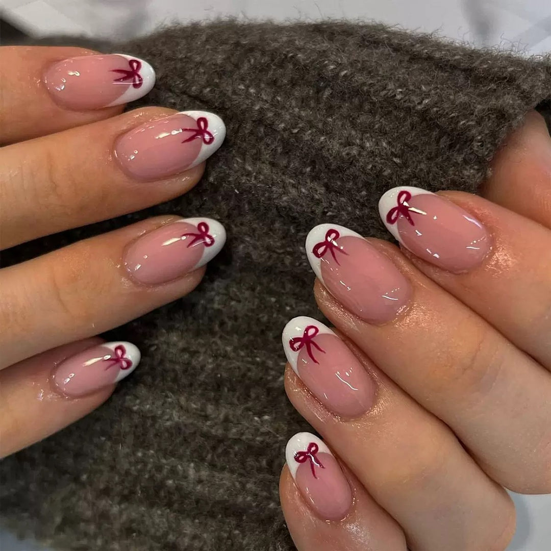 Kunstnagelset mit eleganten Schleifen und French-Spitzen Karnz