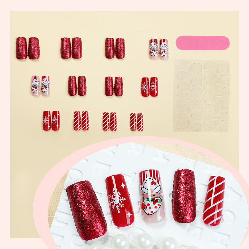 Kunstnagelset mit festlichen Weihnachtsmotiven und Glitzer Karnz