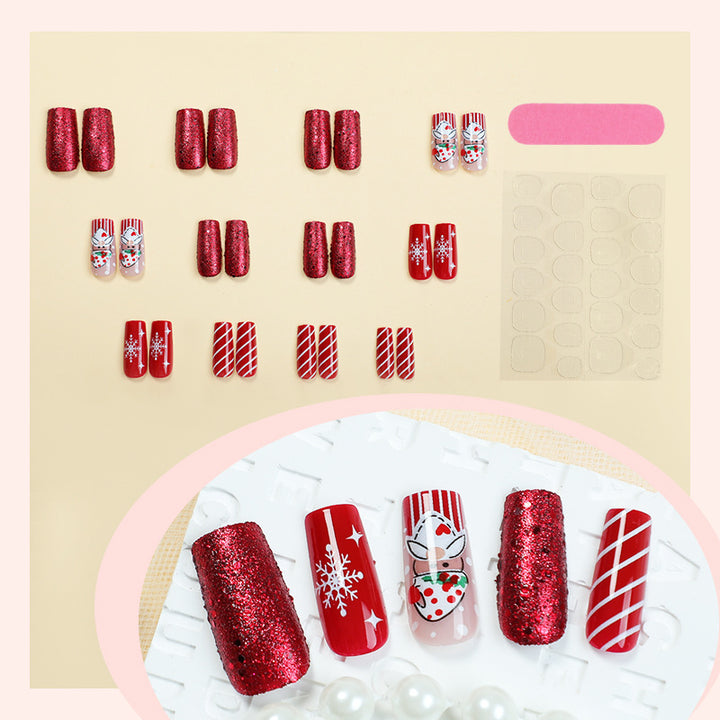 Kunstnagelset mit festlichen Weihnachtsmotiven und Glitzer Karnz