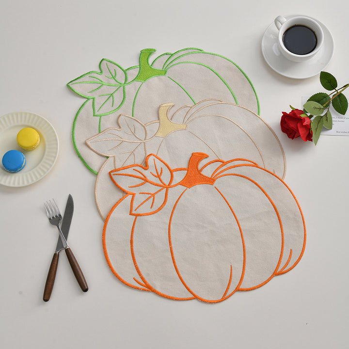 Saisonales Tischset Platzmatte aus Leinen in Kürbis‑Silhouette mit farbigem Stickrand