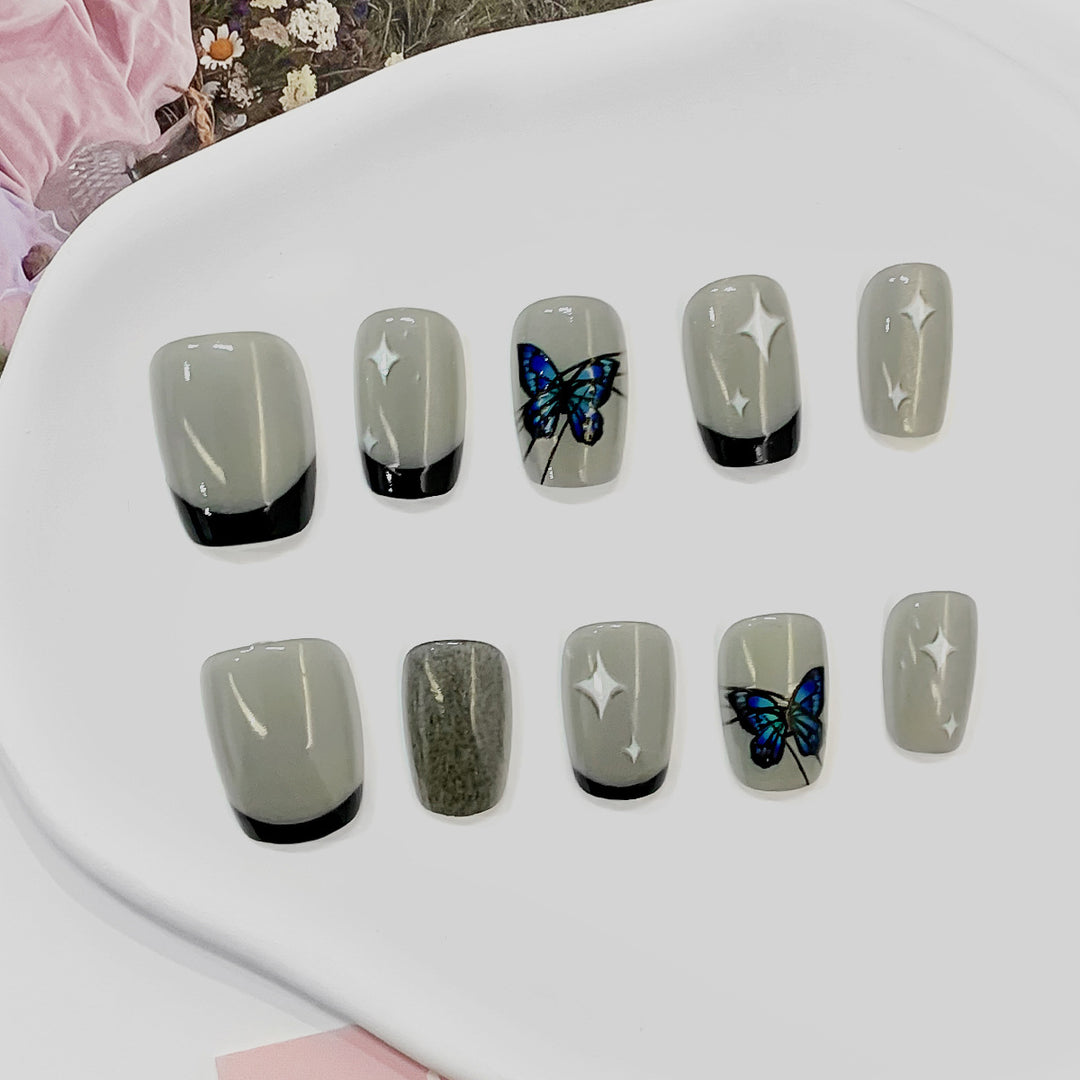 Kunstvolle Nagelspitzen mit Schmetterlings-Motiven Karnz