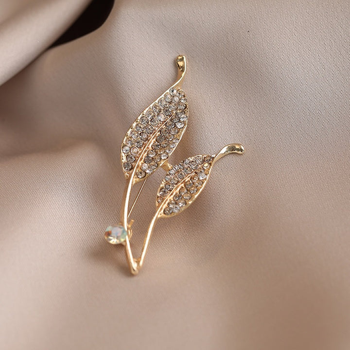 Elegante Brosche mit Blattform und Kristallen Karnz