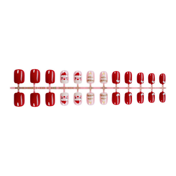 Kunstnagelset mit festlichen Weihnachtsmotiven und Glitzerakzenten Karnz