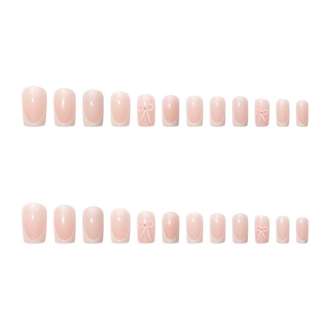 Kunstnagelset mit eleganten Schleifen- und Glitzerakzenten Karnz