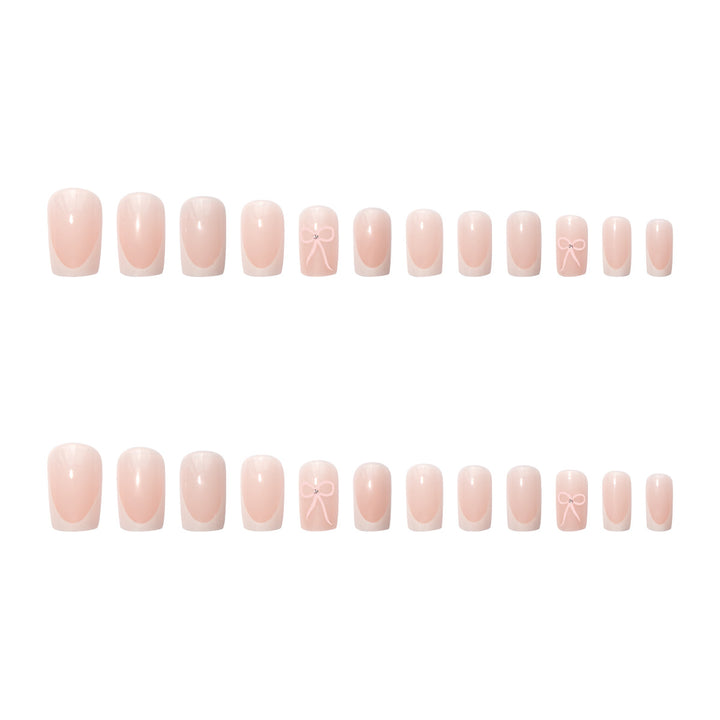 Kunstnagelset mit eleganten Schleifen- und Glitzerakzenten Karnz