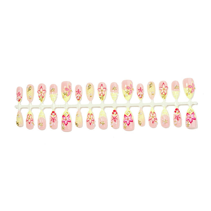 Kunstnagelset mit zarten floralen Verzierungen und Glitzerakzenten Karnz