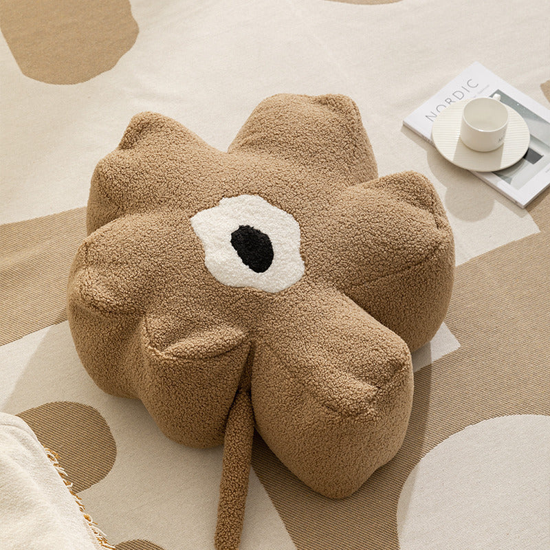 Blumenförmiger Bodensitzpouf mit Bouclé‑Bezug und segmentierter Polsterung